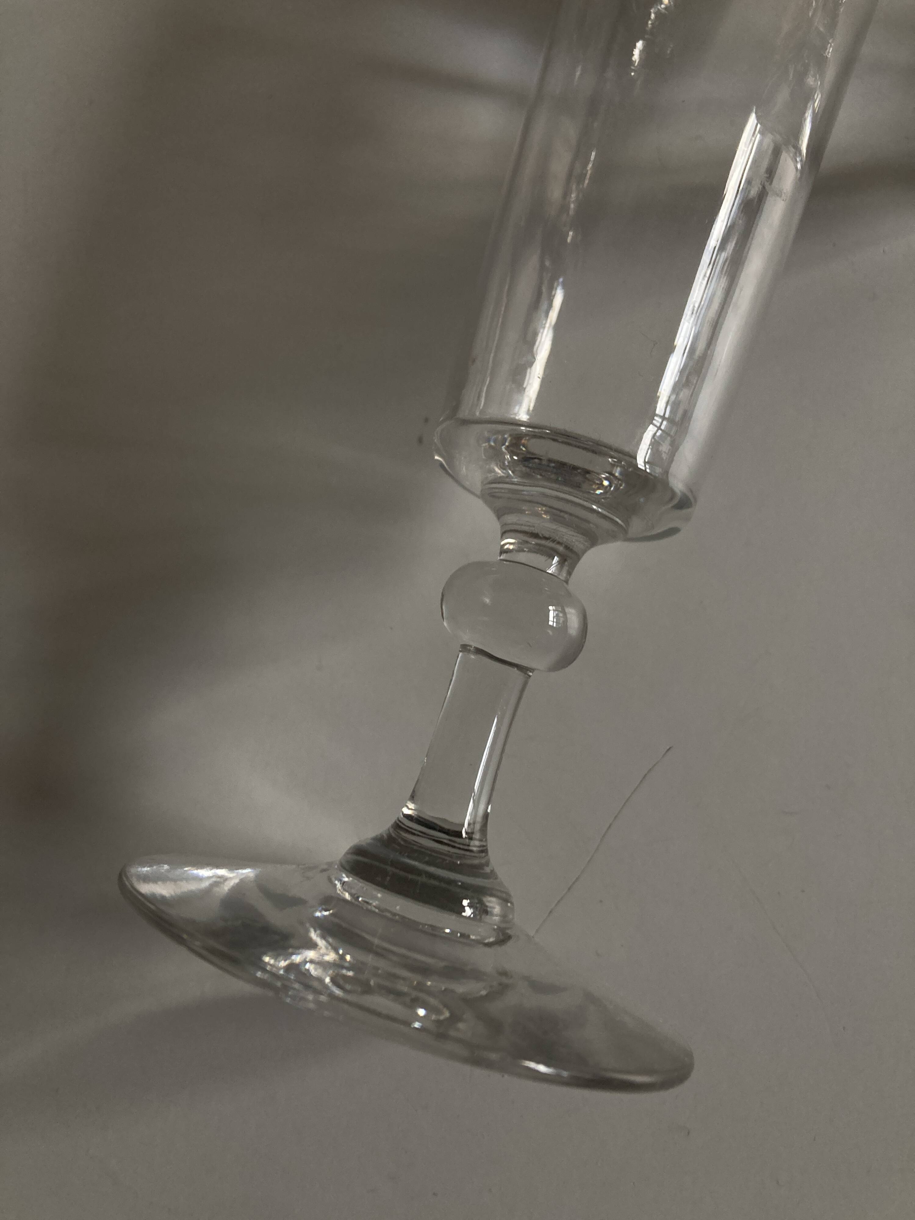Pair of crystal champagne flutes with a button foot, 1960.