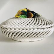 Covered basket in white woven ceramic and fruit slip.
