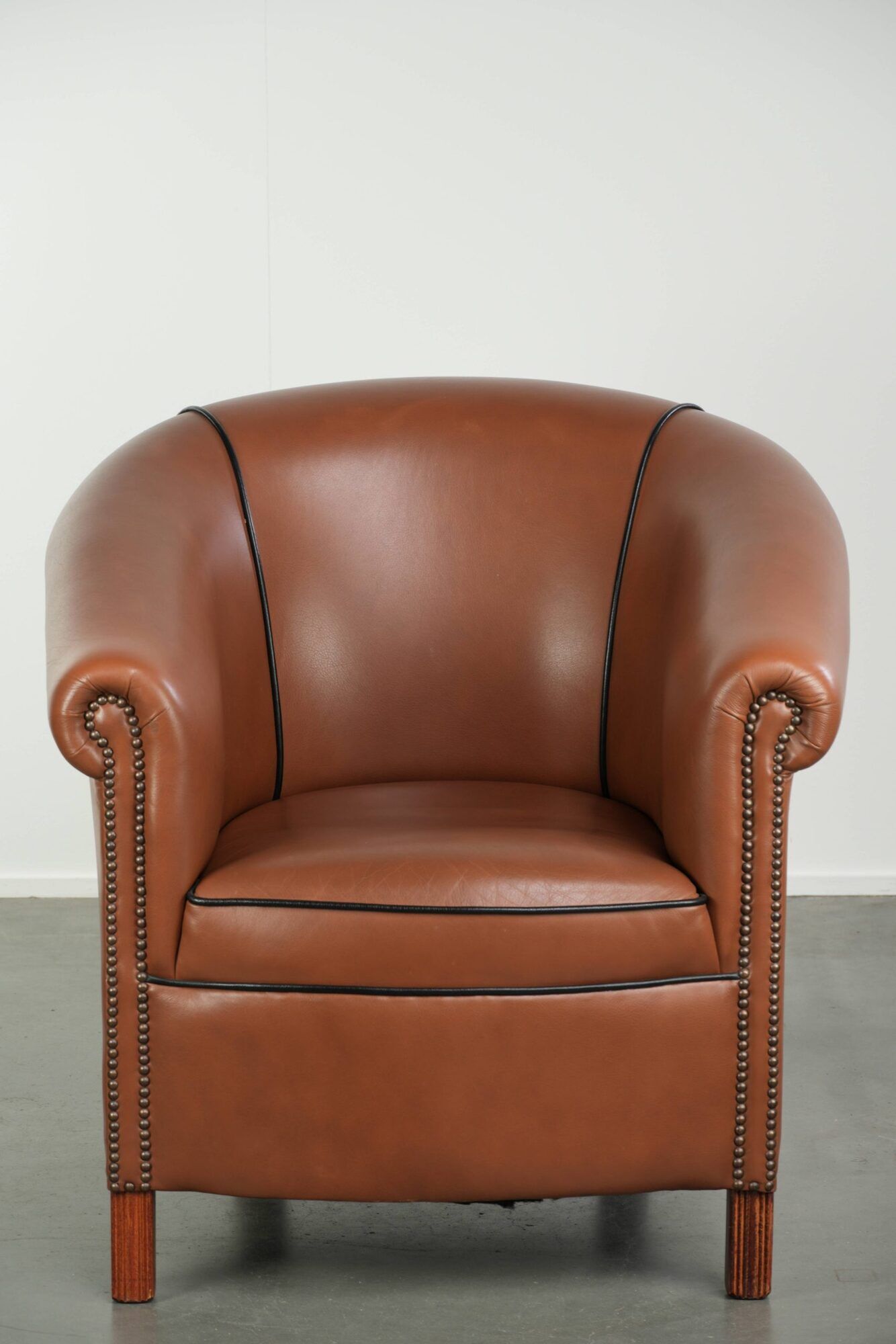 Cowhide club armchair in English style with comfortable seating.