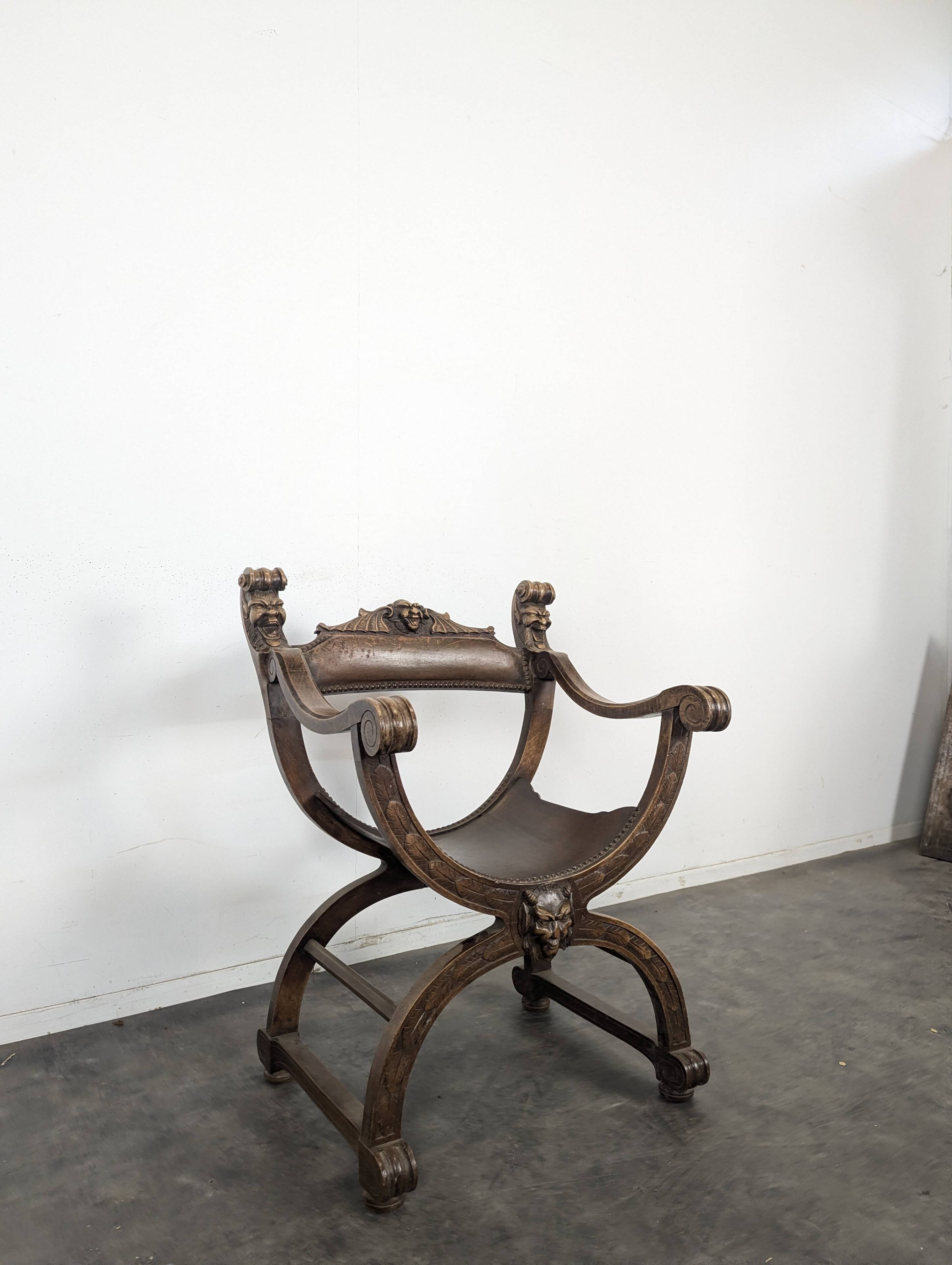 Curule chair Dagobert in carved walnut with lion heads.