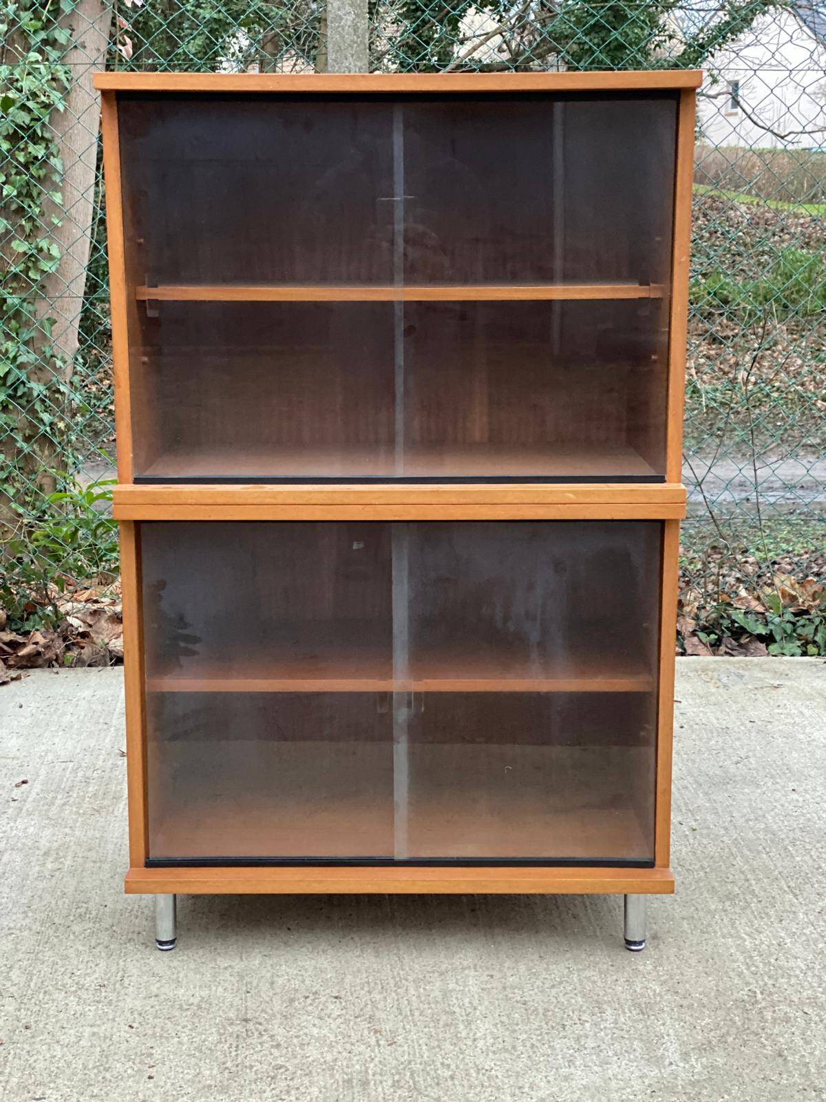 Scandinavian wooden buffet cabinet with sliding glass doors.