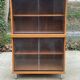 Scandinavian wooden buffet cabinet with sliding glass doors.