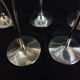 Lot of 12 silver metal flutes on brass stand