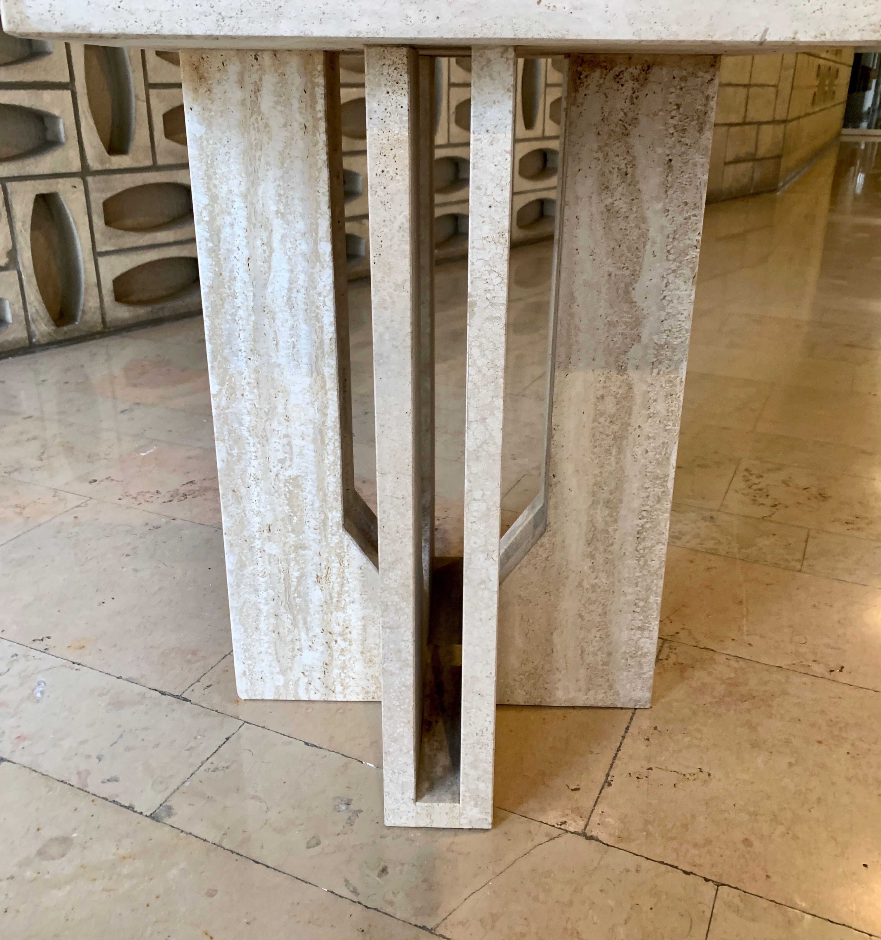 Round travertine dining table with double cross foot