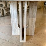 Round travertine dining table with double cross foot