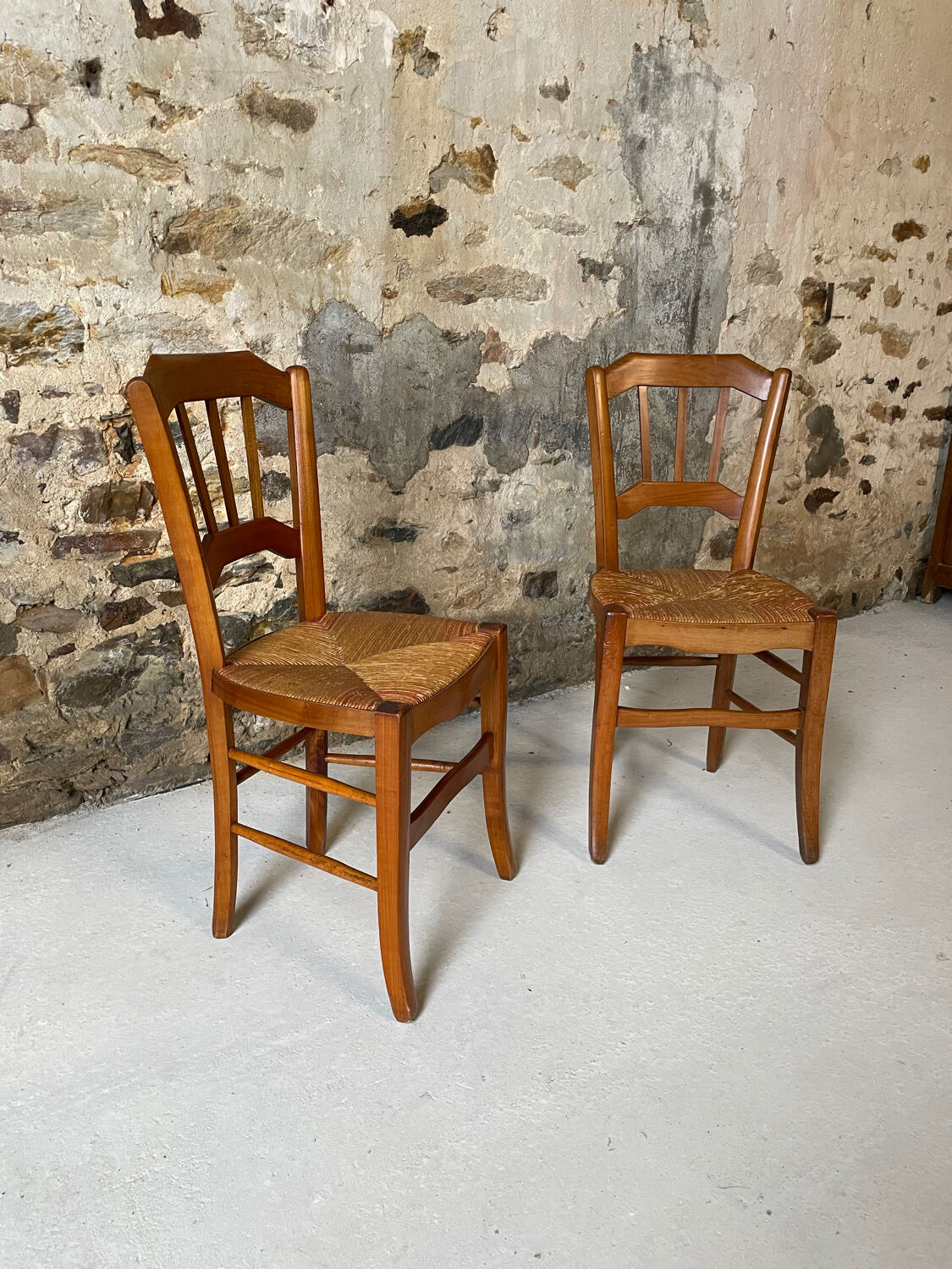 Set of 2 antique wooden and straw chairs.