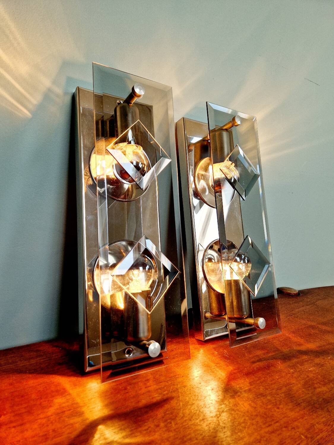 Pair of chrome metal and smoked glass wall sconces, 1970s.