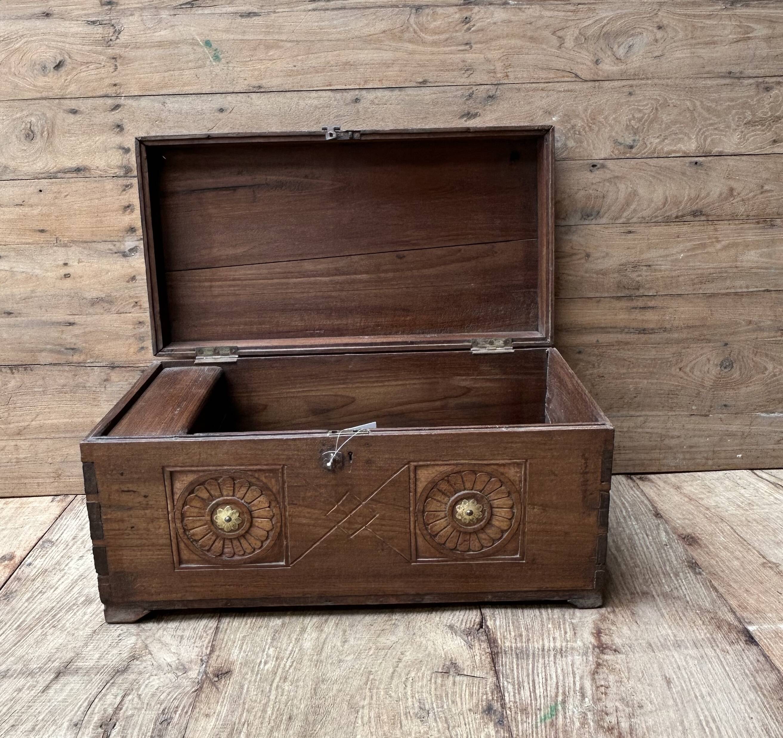 Teak chest from Burma with carved rosettes.