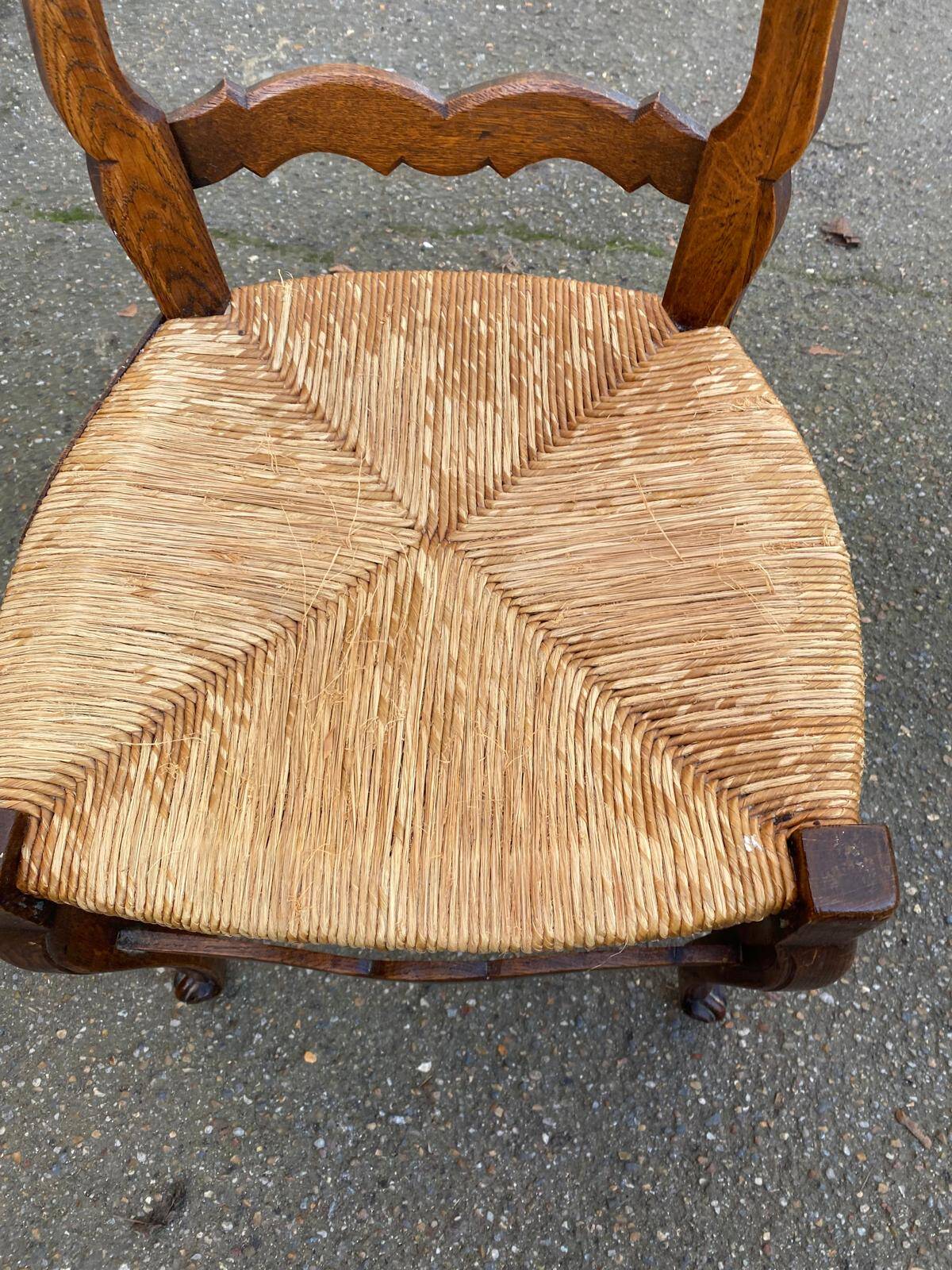 Louis XV 18th century solid wood dining chair with a straw seat.