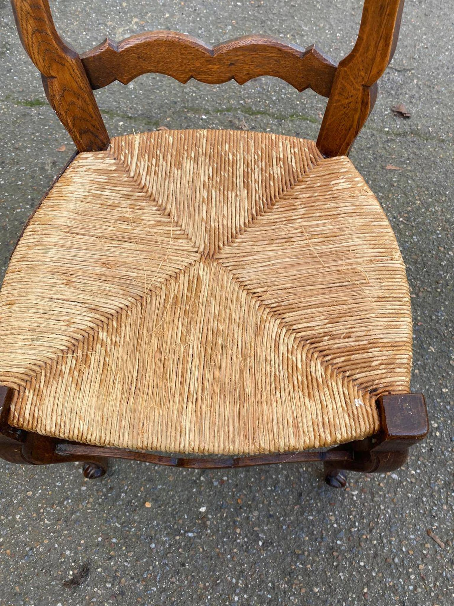 Louis XV 18th century solid wood dining chair with a straw seat.