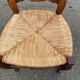 Louis XV 18th century solid wood dining chair with a straw seat.