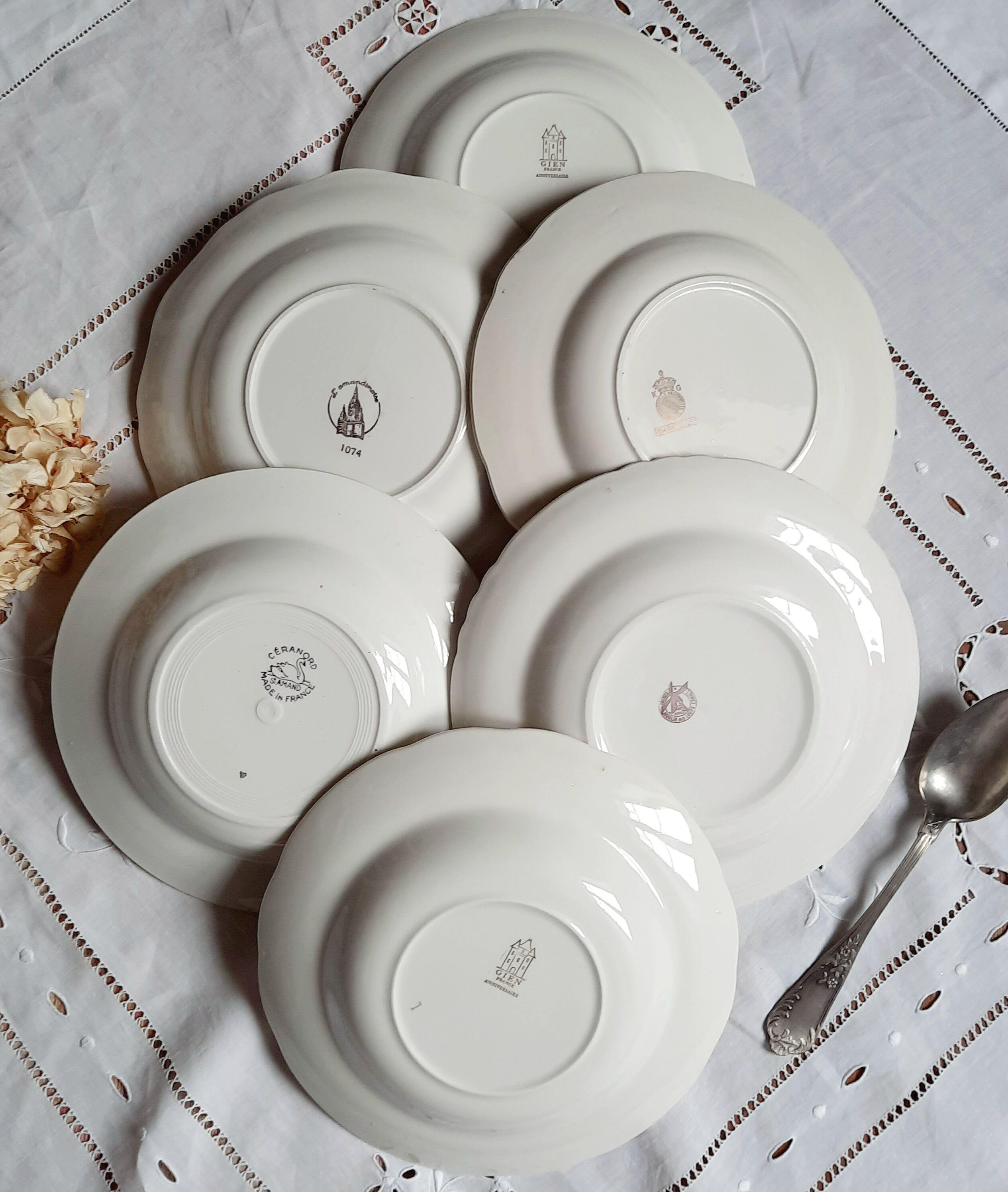 Old hollow plates mismatched in earthenware with gilded edges