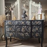Large black chest of drawers with golden floral decoration