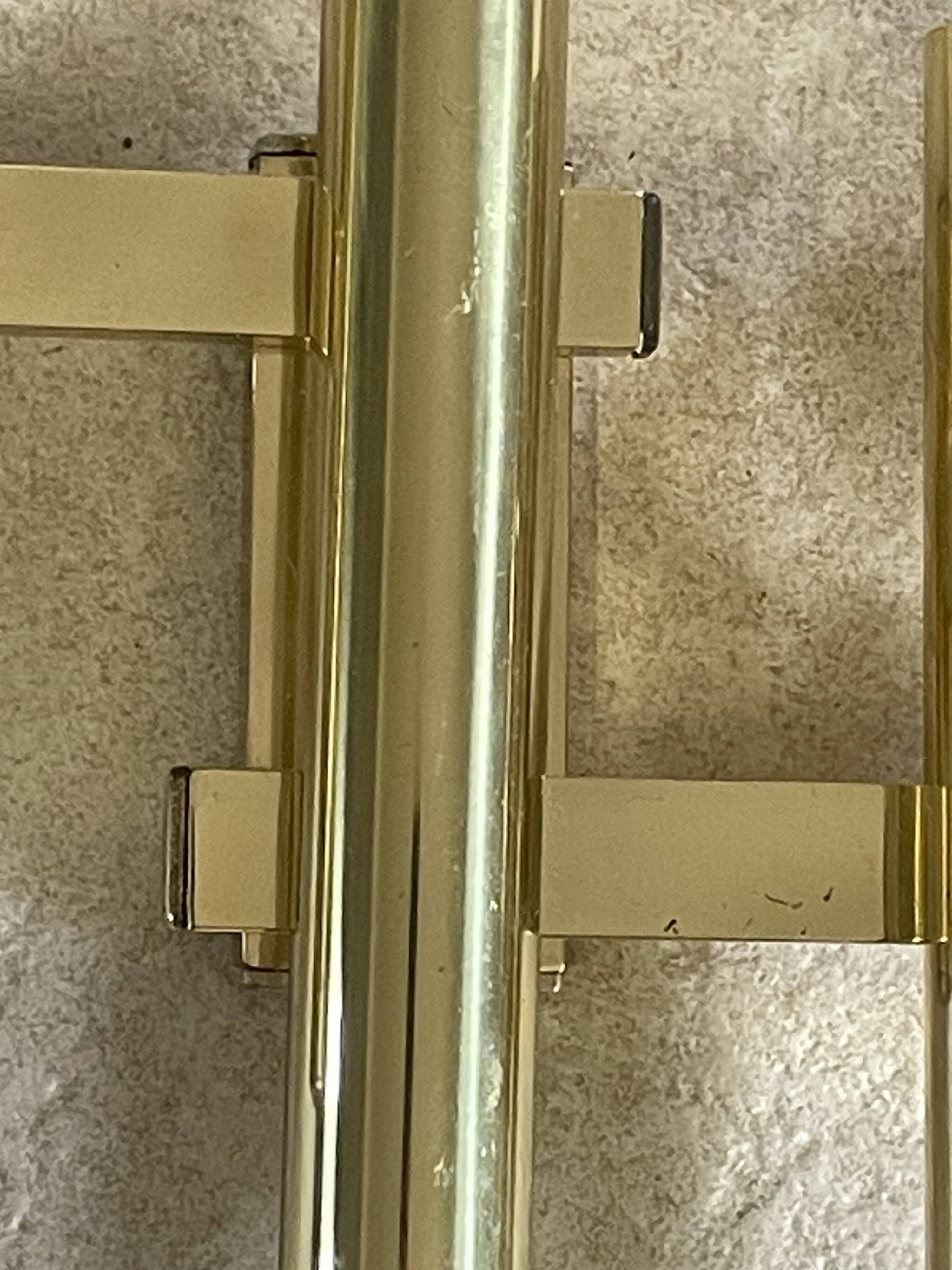 Tubular wall sconces in brass, Italian design from the 1970s, attributed.