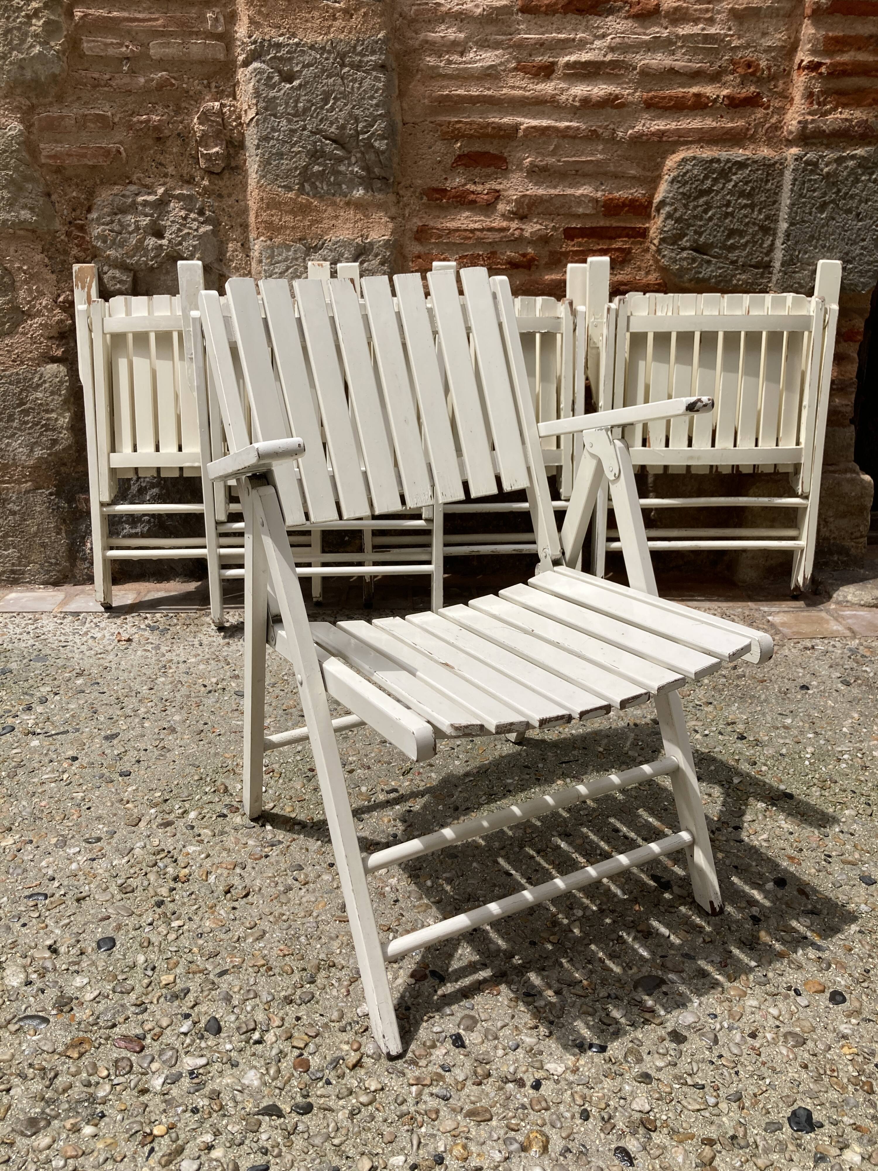 Five wooden garden armchairs
