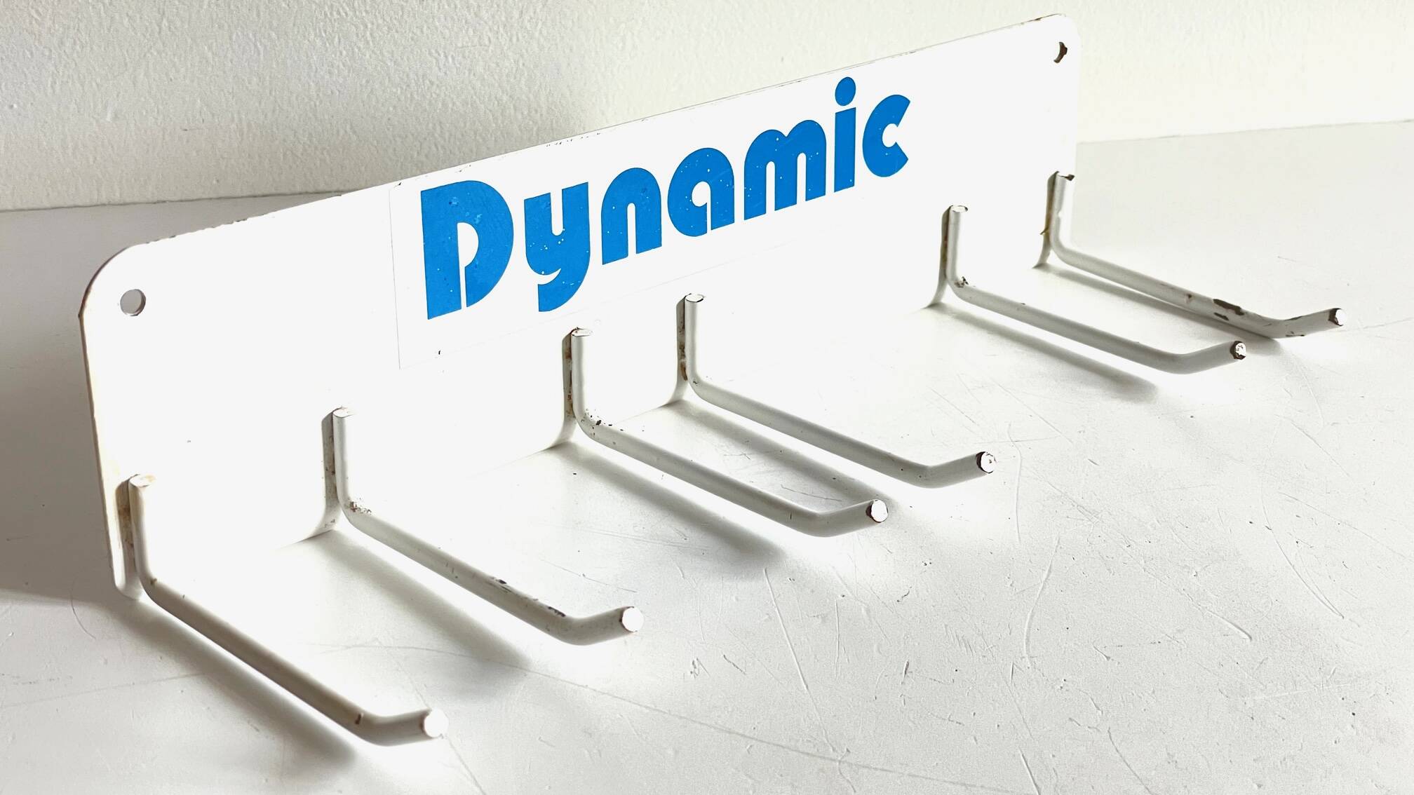 Vintage white metal wall trade coat rack