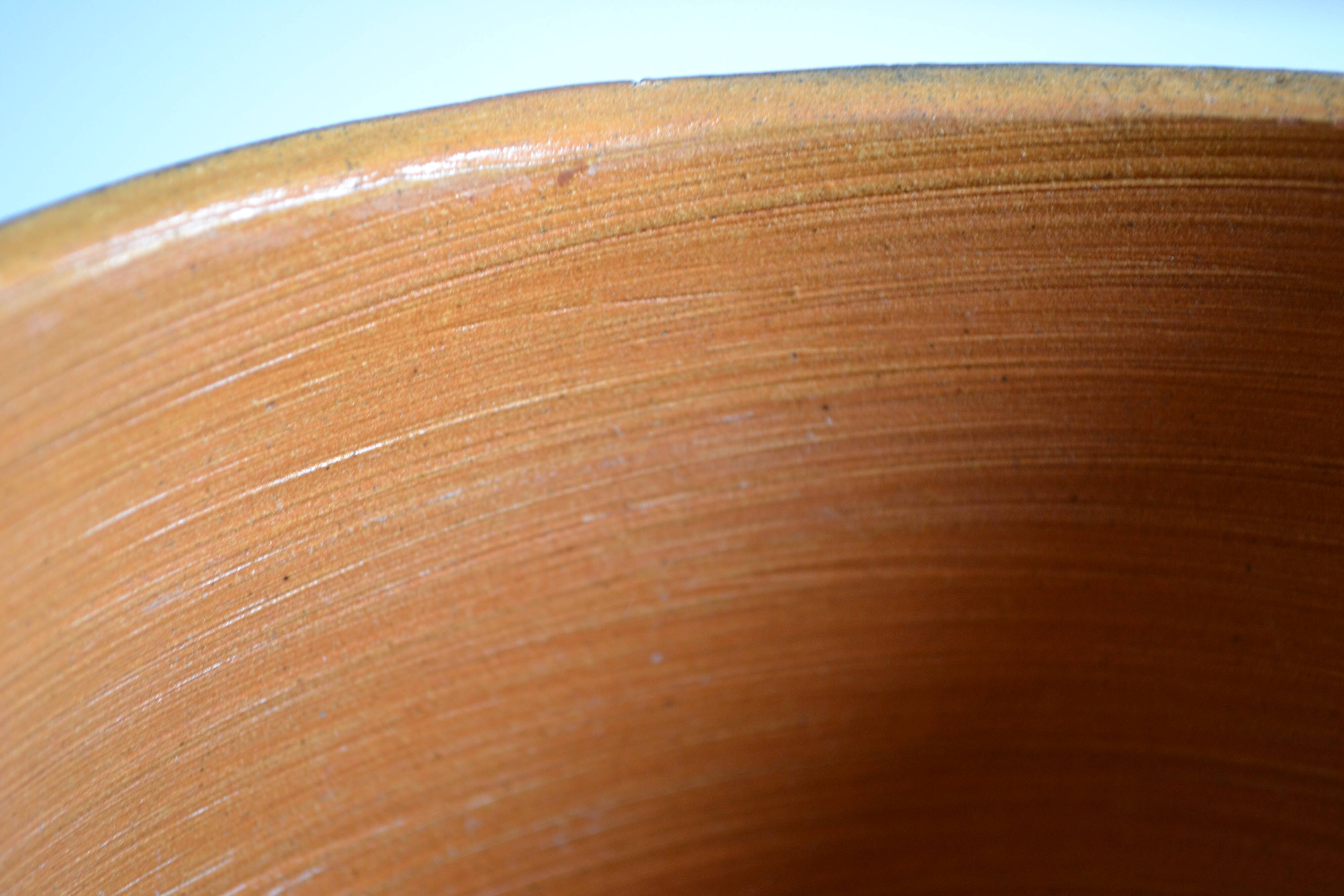 Ceramic cache pot or pocket emptying dish with a signature fish to identify.