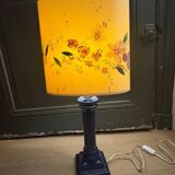 Corinthian column lamp base in blue with a lampshade of dried flowers.