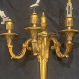 Pair of gilt bronze wall sconces with three lights in the Louis XVI style.