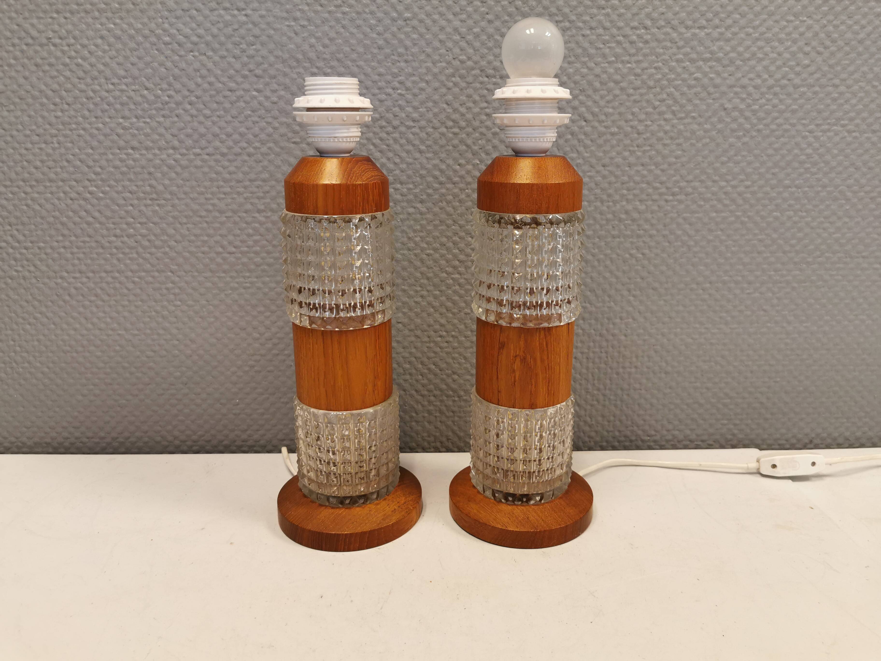 Swedish table lamps made of teak wood and hard pressed crystal glass.