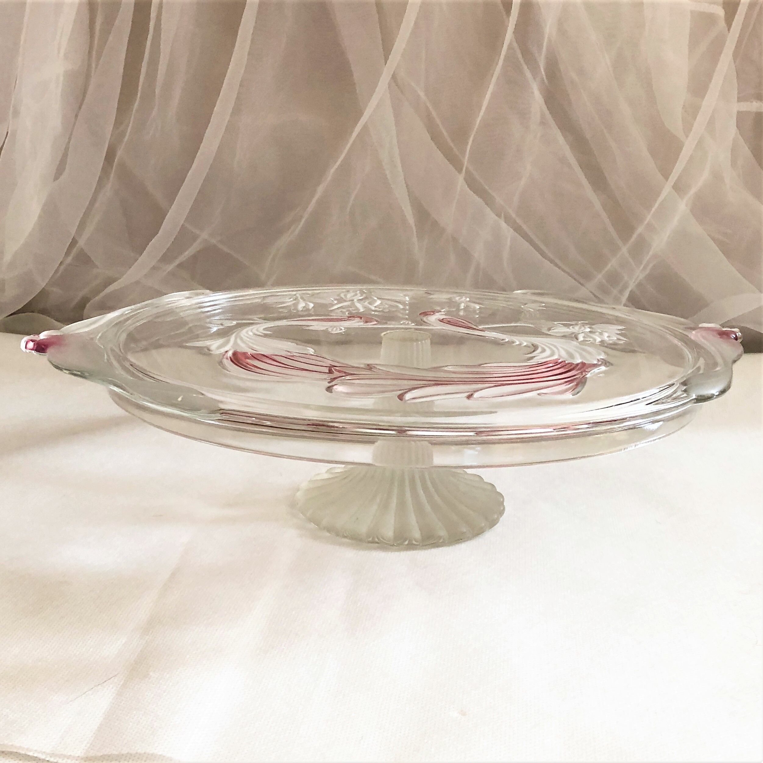Large pie dish cakes on pedestal decorated with peacocks