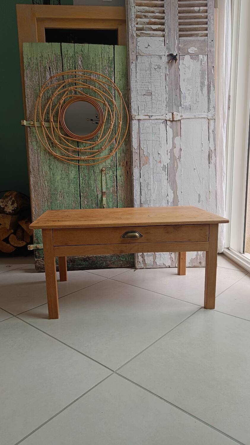 Coffee table with raw wood and a large drawer.