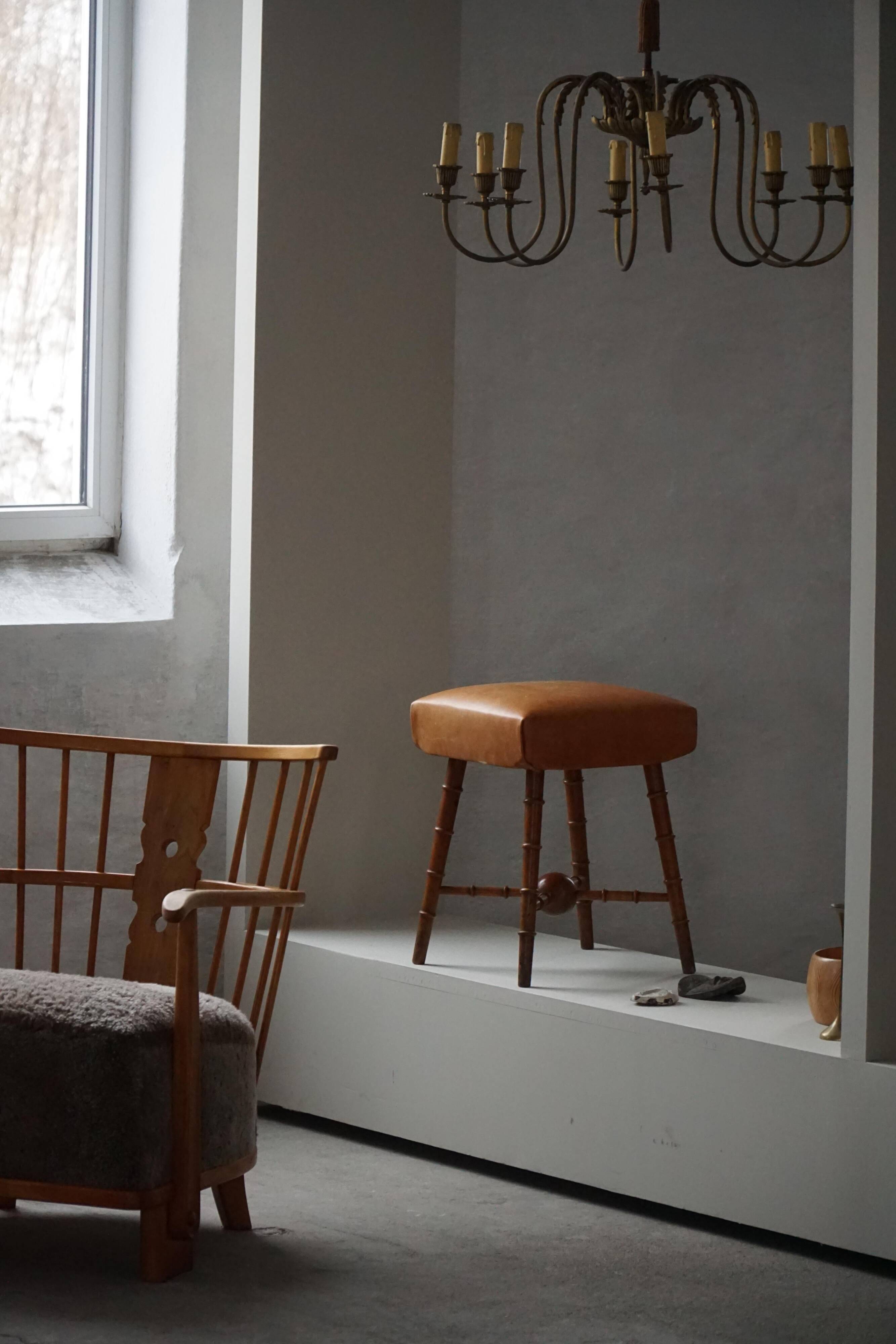 Turned wooden stool with leather seat, mid-20th century, Danish modern.