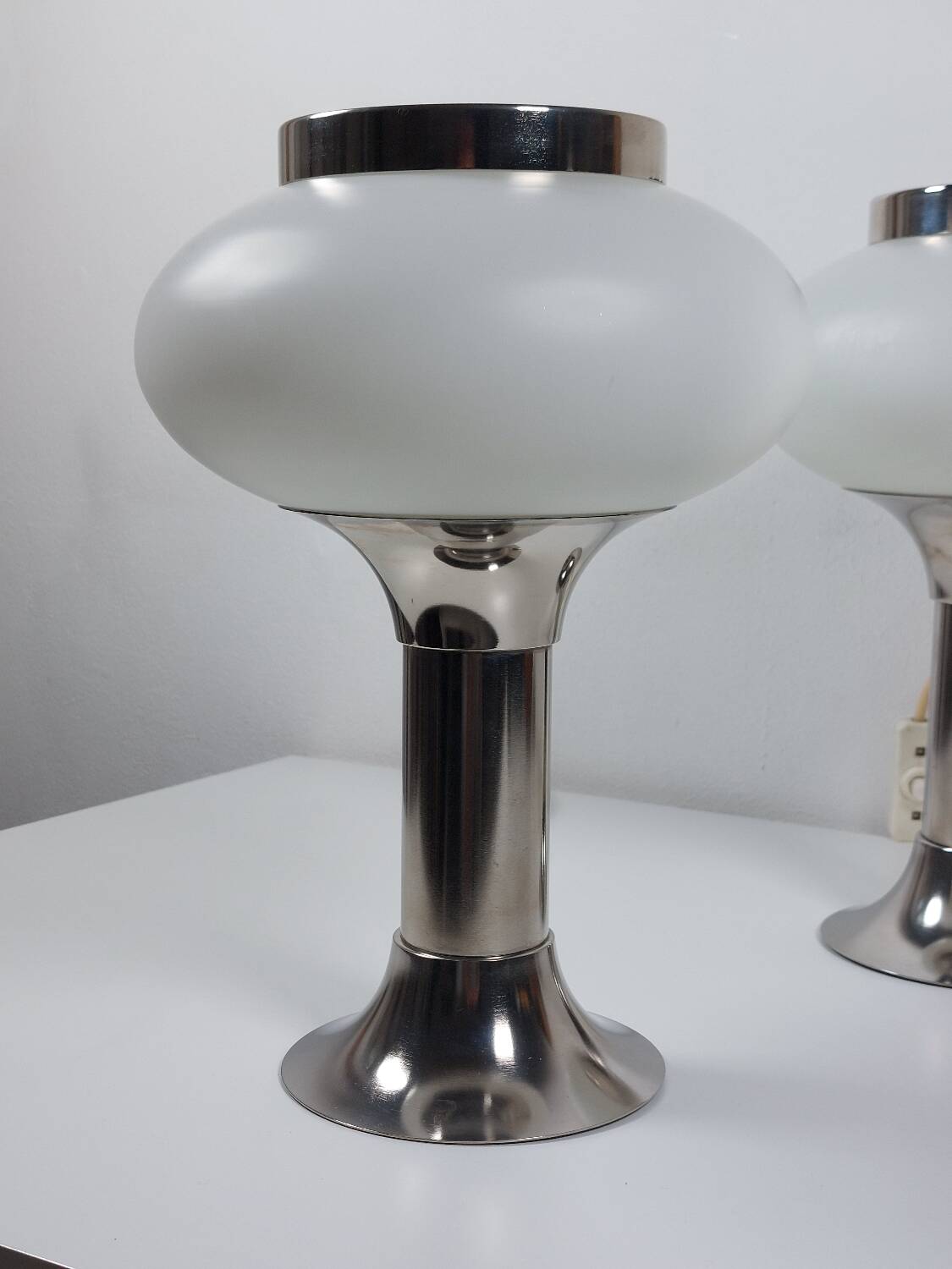 Pair of vintage futuristic style table lamps in chrome and opal glass.