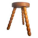 Round tripod stool in carved wood
