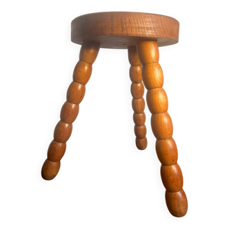 Round tripod stool in carved wood
