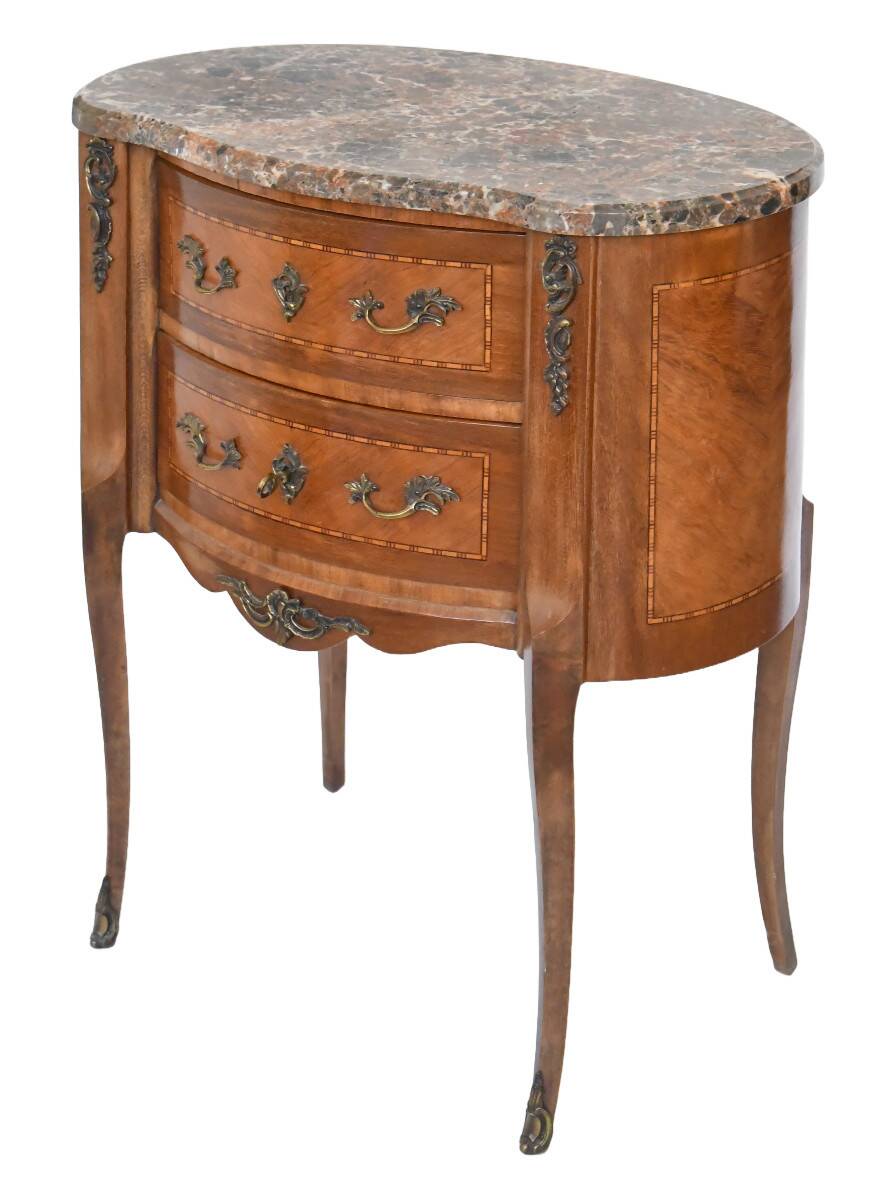 Small kidney-shaped chest of drawers in Transition style.