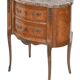 Small kidney-shaped chest of drawers in Transition style.