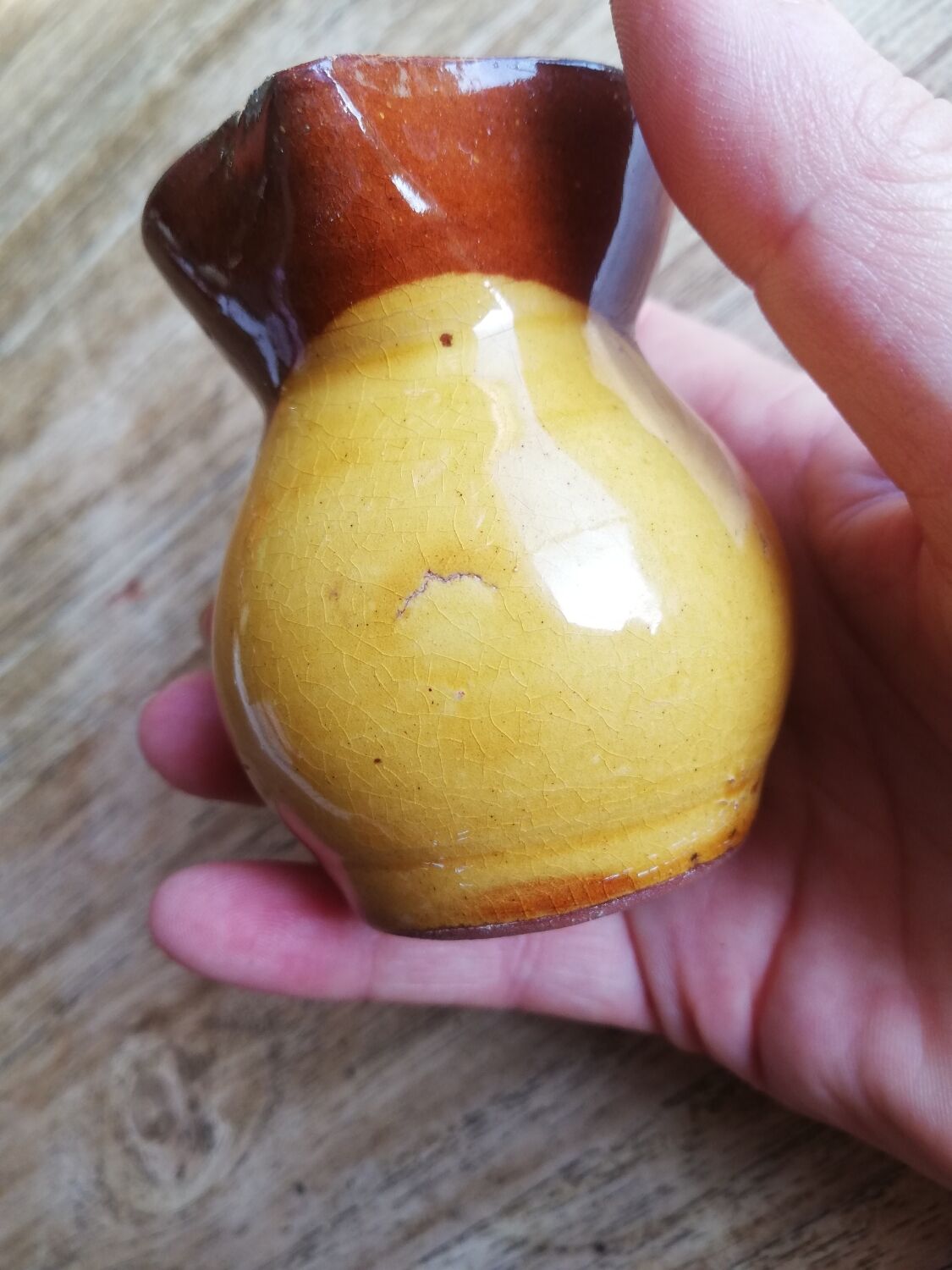 Small two-tone brown-yellow terracotta pitcher