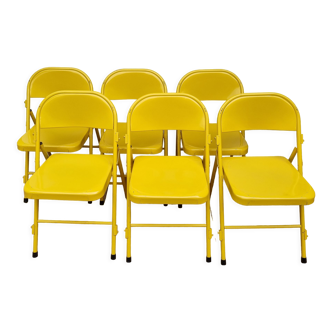 Set of six yellow Eurosit folding metal chairs