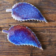 A set of 4 handcrafted pottery knife rests in blue.