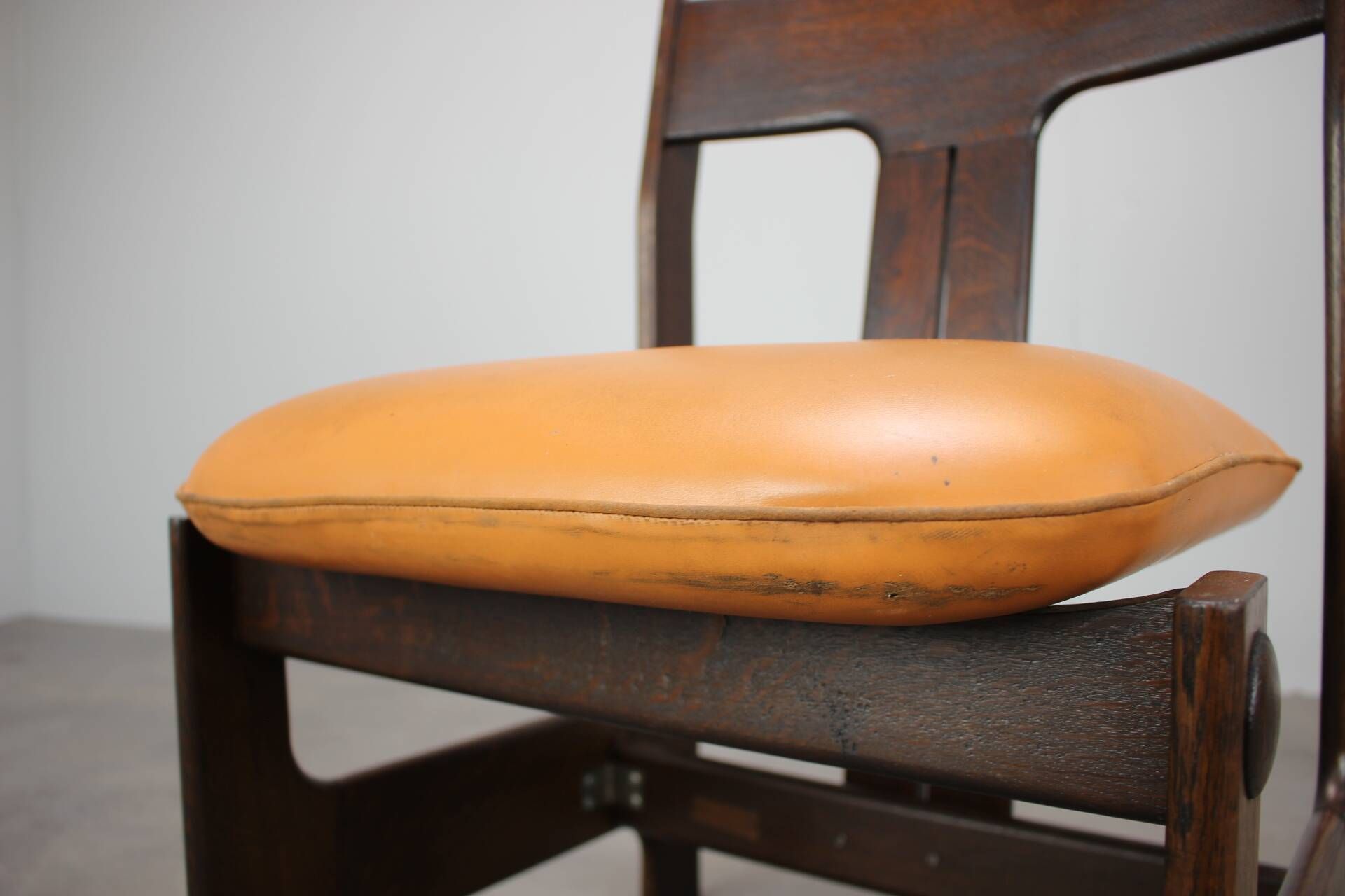 Vintage German sculptural chair from the 1970s in wood with orange faux leather.