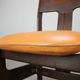 Vintage German sculptural chair from the 1970s in wood with orange faux leather.