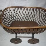 Cradle of doll in rattan on wheels