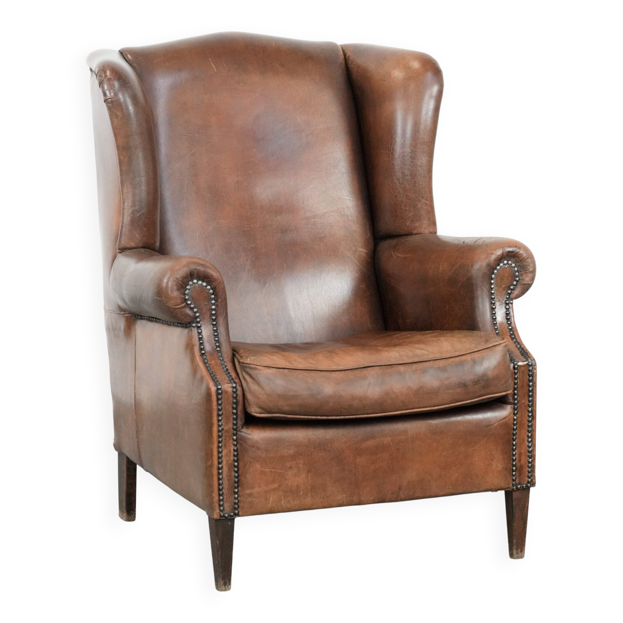 Vintage wingback armchair made of sheepskin leather with beautiful colours
