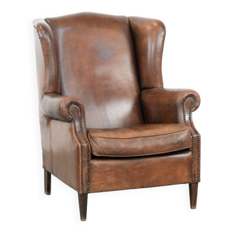 Vintage wingback armchair made of sheepskin leather with beautiful colours
