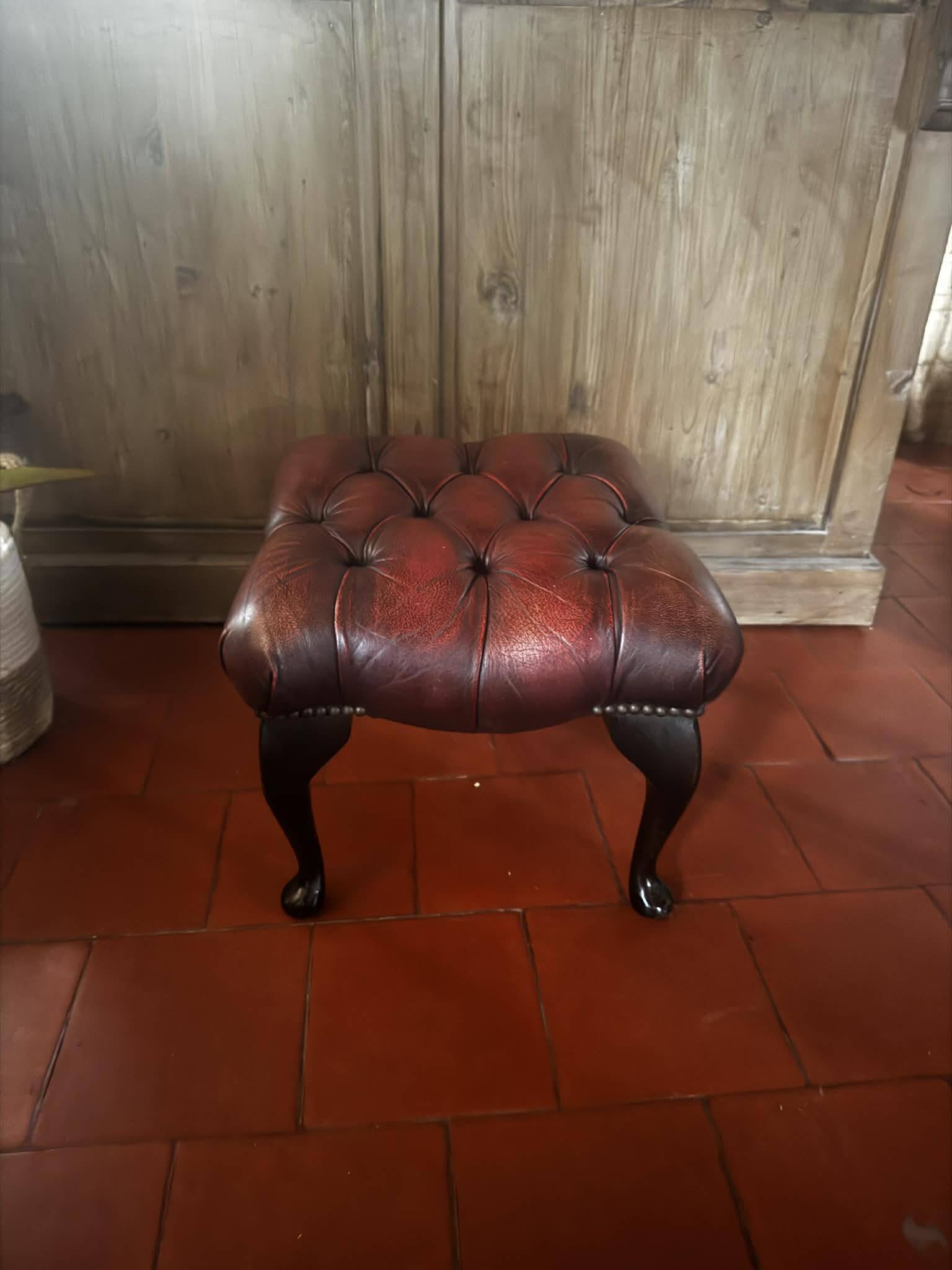 Red leather footrest in Chesterfield style, vintage 1970s.