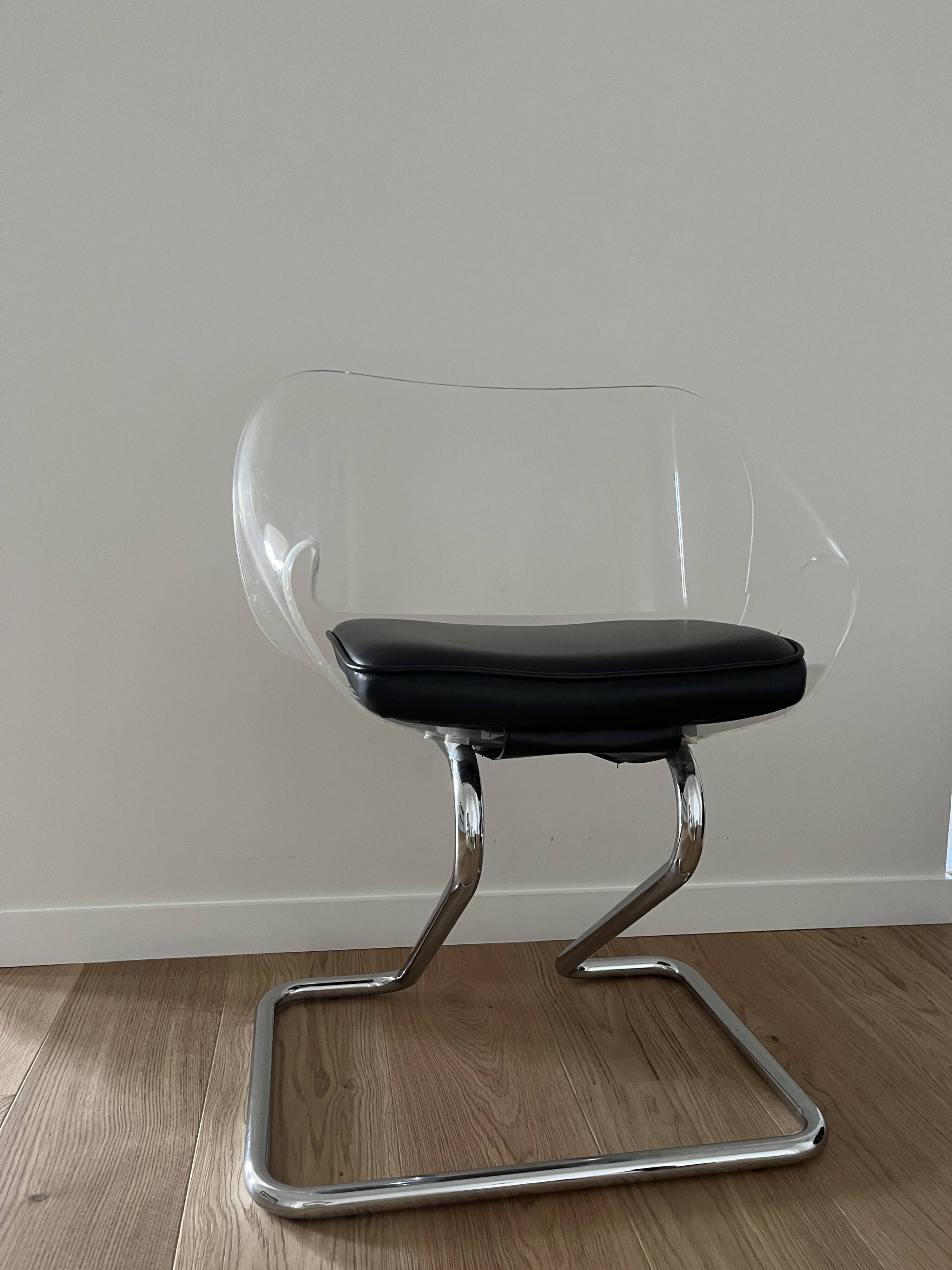 1970s chairs in acrylic and metal designed by Harvey Guzzini.