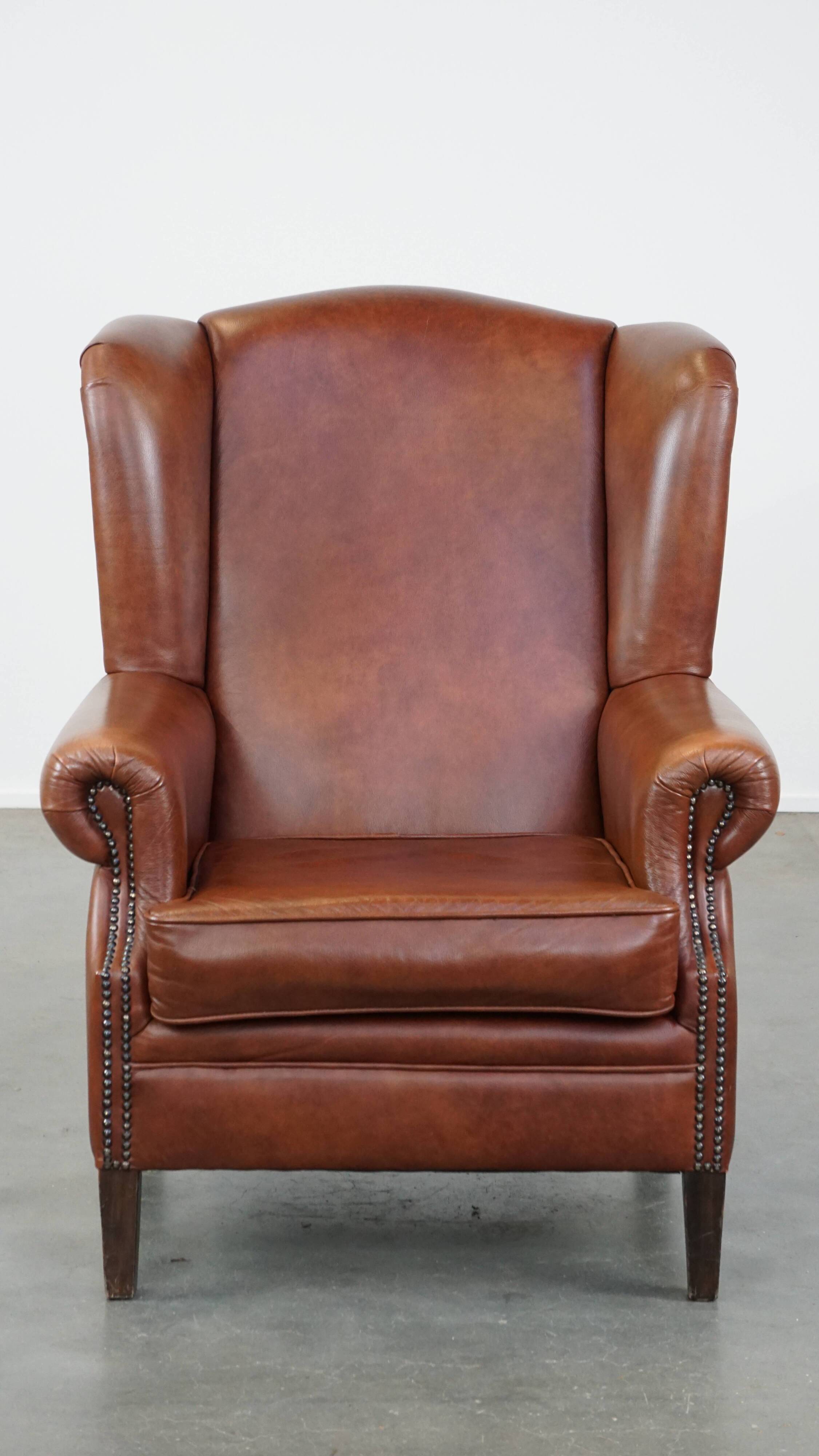 Cognac-colored cowhide wingback chair