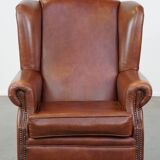 Cognac-colored cowhide wingback chair