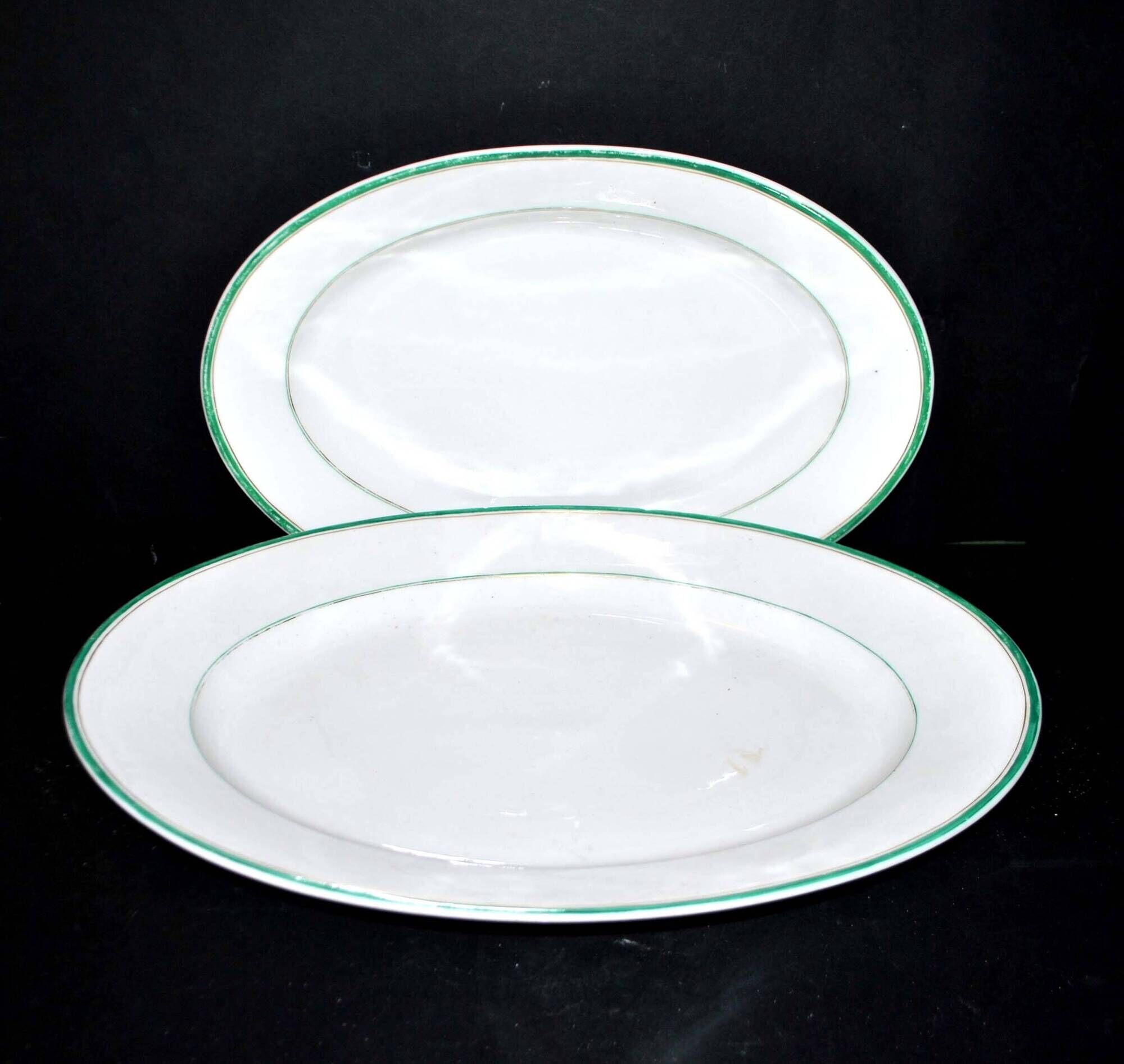 Limoges set of 2 old oval porcelain dishes with green and gold edging