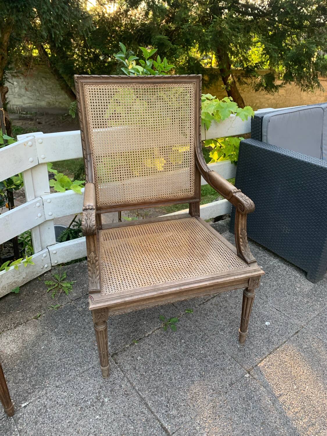 Wooden armchair with caning in Louis XVI style