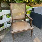 Wooden armchair with caning in Louis XVI style
