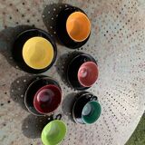 Coffee service composed of 5 cups and saucers in black earthenware and different colored interiors