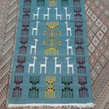 Blue carpet with gazelle patterns woven by hand