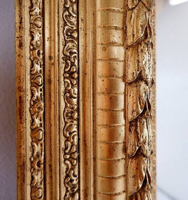 Large gilded wood and stucco mirror with foliage